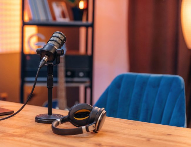 Microphone and headphones are on the table, room for podcasts.